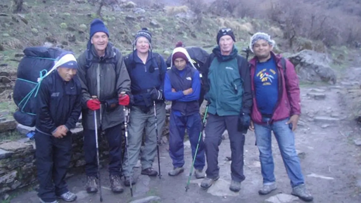 Trekkers, walking through the diverse region with the help of a porter and guide on Annapurna Base Camp Trekking 